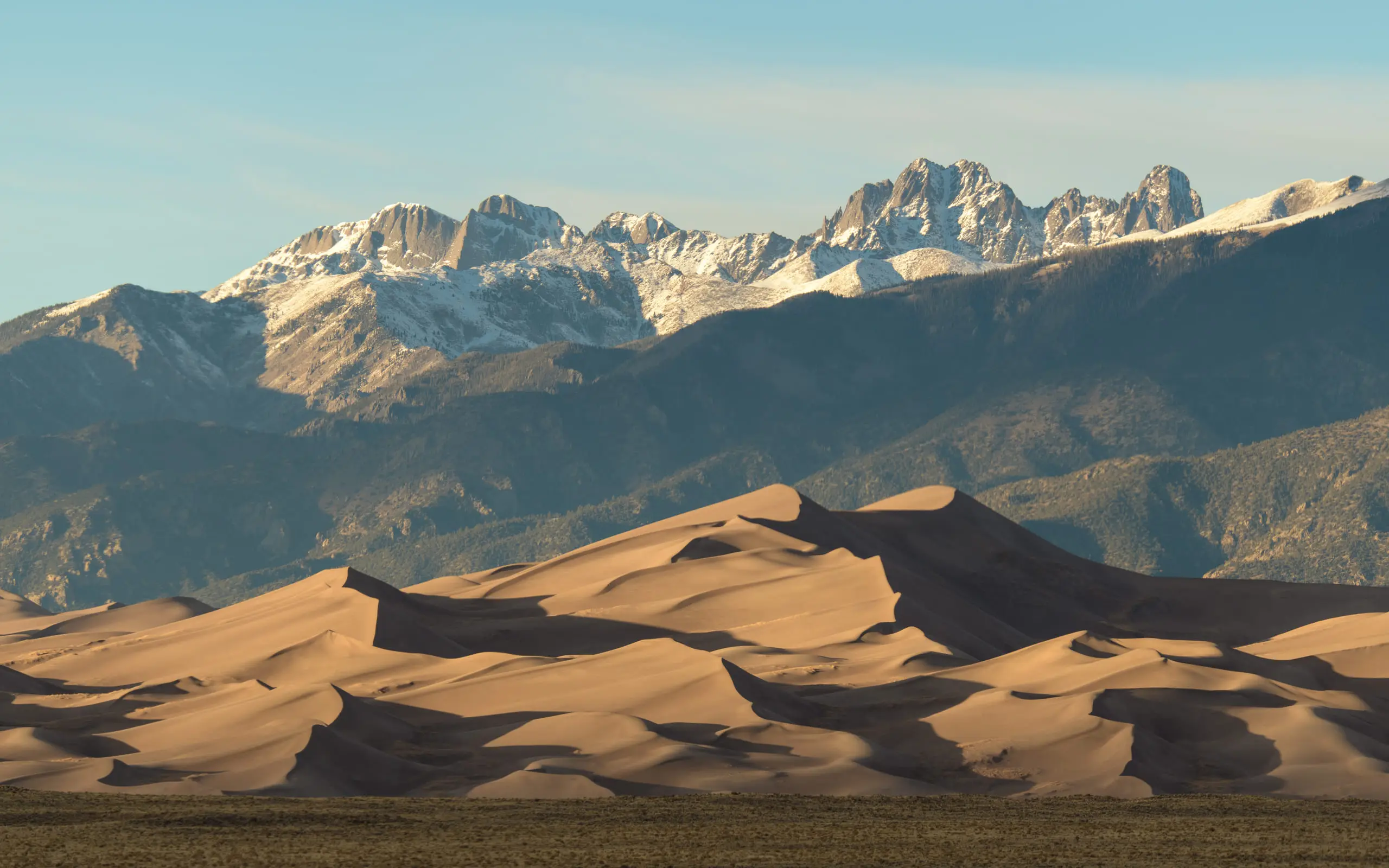 Sand dune landscape beneath a wide sky